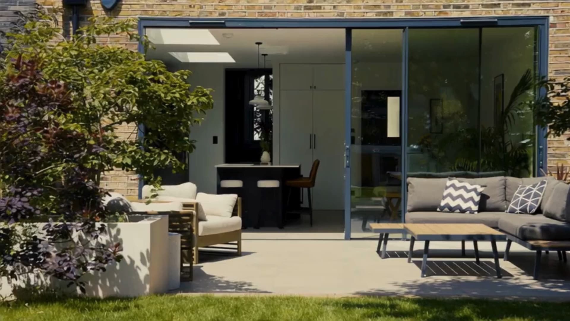 Sunlit patio and open-plan kitchen of a London new build home