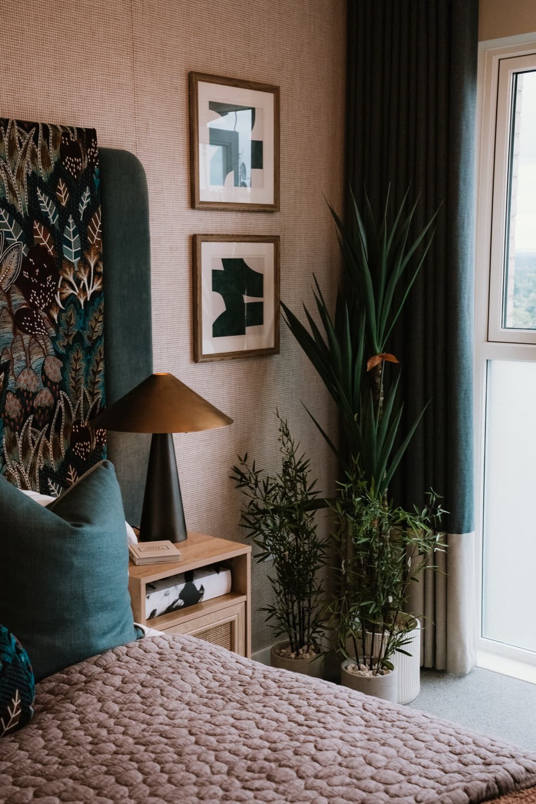 Styled new build bedroom with feature headboard and plants